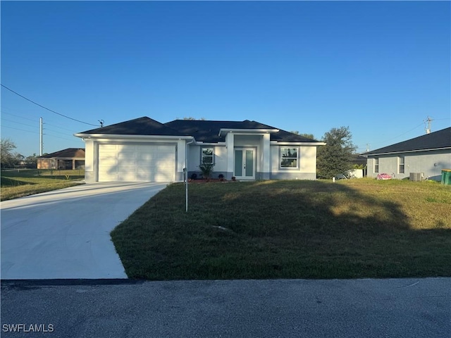 view of front of home with central AC unit, a garage, and a front lawn