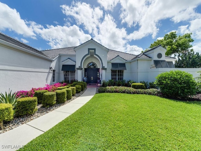 ranch-style house with a front lawn