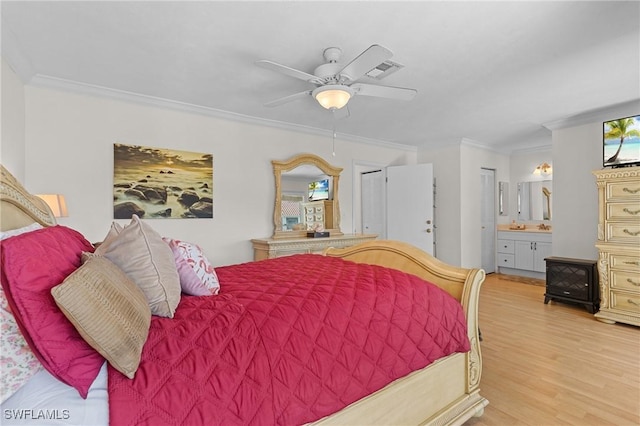 bedroom with ensuite bathroom, ceiling fan, light hardwood / wood-style floors, and crown molding