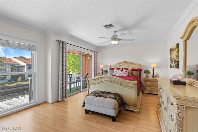 bedroom with access to outside, multiple windows, ceiling fan, and ornamental molding