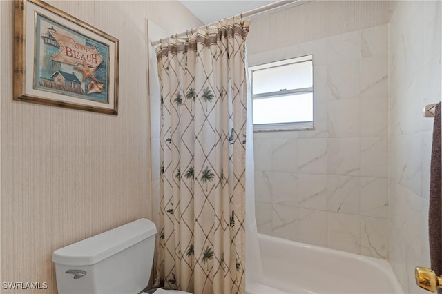 bathroom featuring shower / bath combo and toilet