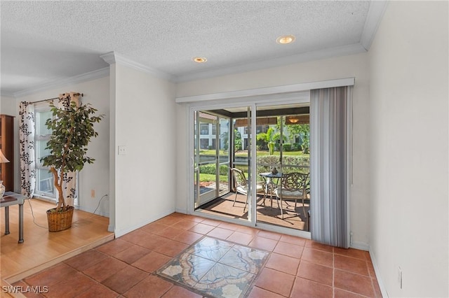 entryway featuring tile patterned flooring, a textured ceiling, and ornamental molding