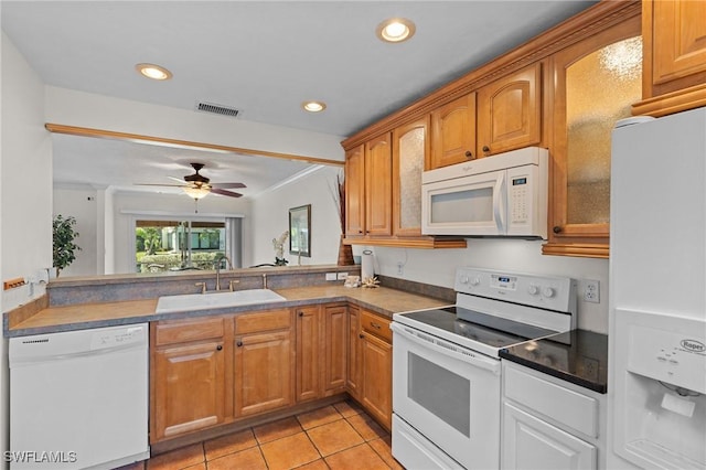 kitchen with light tile patterned floors, white appliances, ceiling fan, and sink