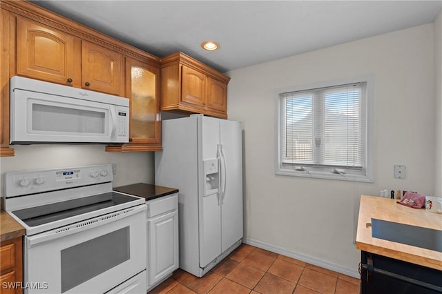 kitchen with light tile patterned floors and white appliances