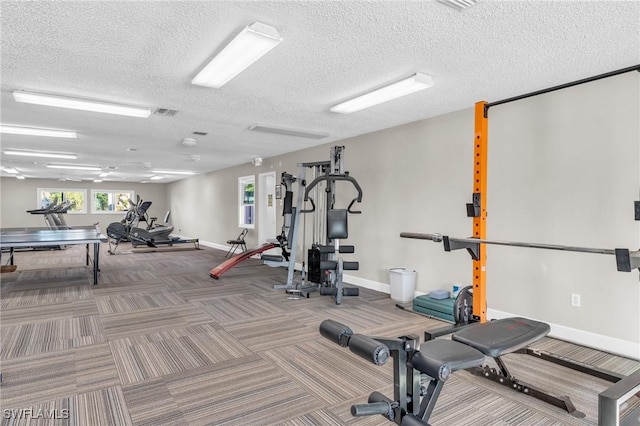 exercise room featuring a textured ceiling