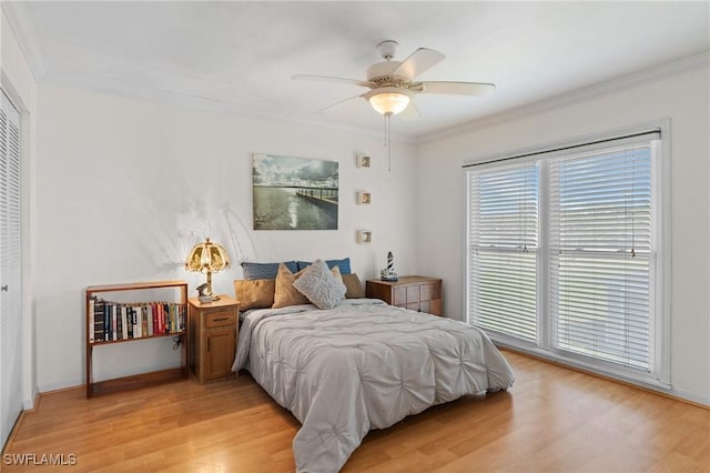 bedroom featuring a closet, ceiling fan, and ornamental molding