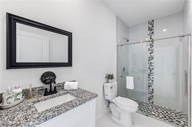 bathroom with vanity, a shower with shower door, and toilet