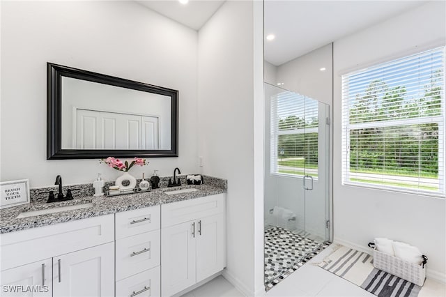 bathroom featuring tile patterned floors, vanity, and an enclosed shower