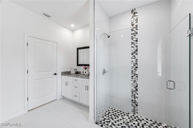 bathroom with tile patterned flooring, vanity, and a shower with door