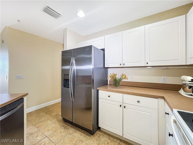 kitchen featuring white cabinets, light tile patterned flooring, visible vents, and stainless steel appliances