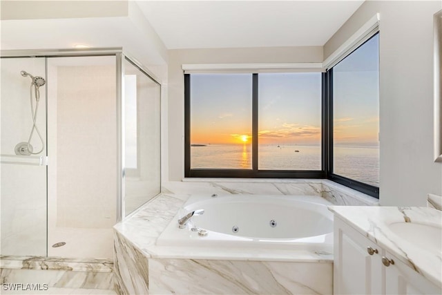 bathroom with vanity, a water view, and separate shower and tub