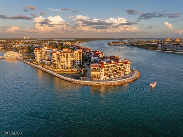 aerial view at dusk featuring a water view