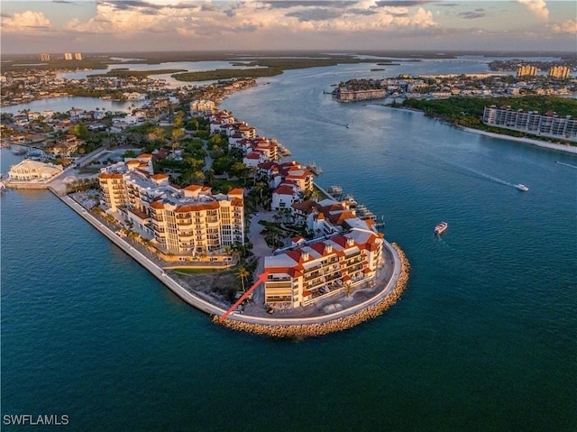 aerial view at dusk featuring a water view