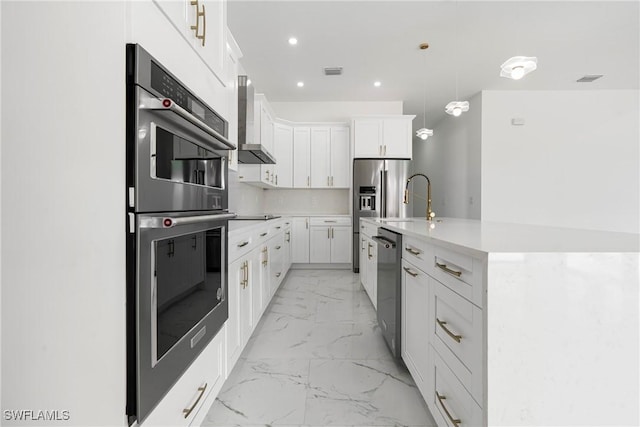 kitchen with white cabinets, decorative light fixtures, a kitchen island with sink, and appliances with stainless steel finishes