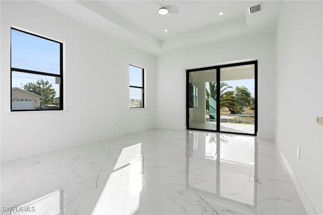 unfurnished room with a raised ceiling