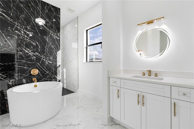 bathroom with a tub and vanity