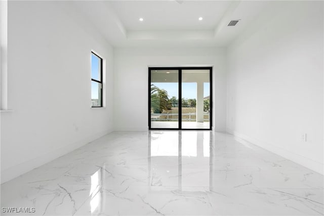 empty room featuring a tray ceiling