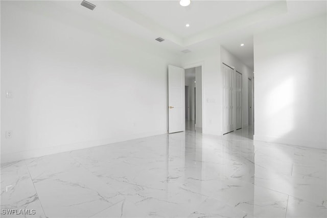 spare room featuring a tray ceiling