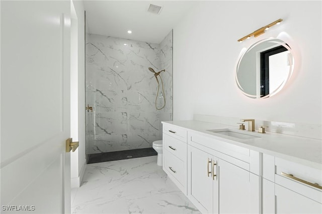 bathroom featuring toilet, vanity, and walk in shower