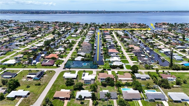 bird's eye view featuring a water view and a residential view