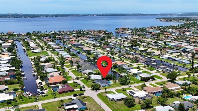 drone / aerial view featuring a residential view and a water view