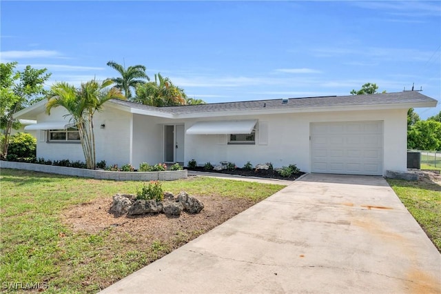 single story home featuring a front yard and a garage