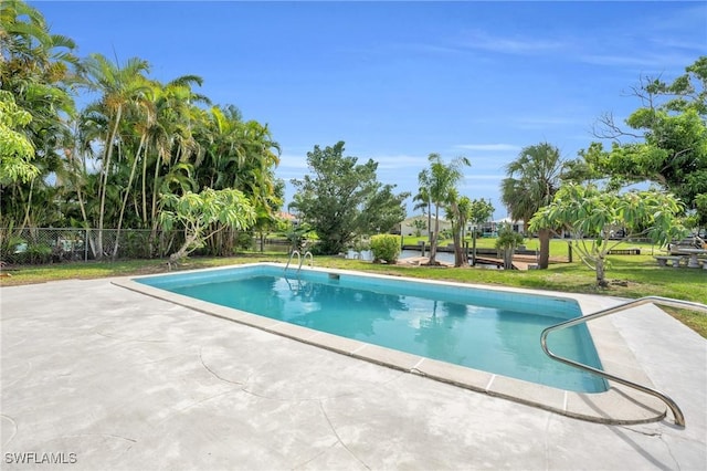 view of pool featuring a patio area and a yard