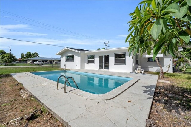 pool with a lawn and fence