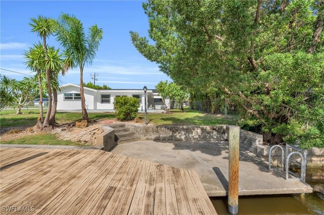 exterior space with a water view, a patio area, and fence