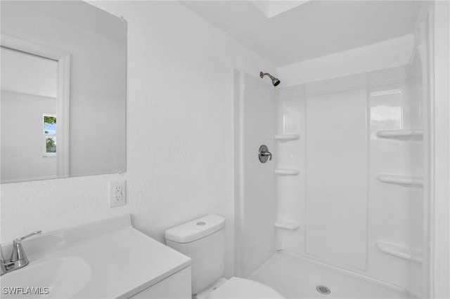 full bathroom with toilet, a shower, and vanity