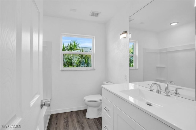 full bathroom with a shower, visible vents, toilet, and wood finished floors