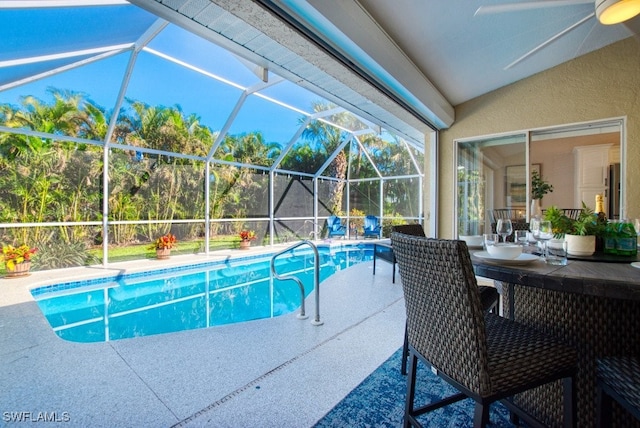 view of swimming pool with a lanai and a patio area