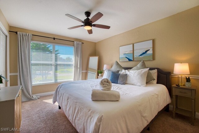 carpeted bedroom with ceiling fan