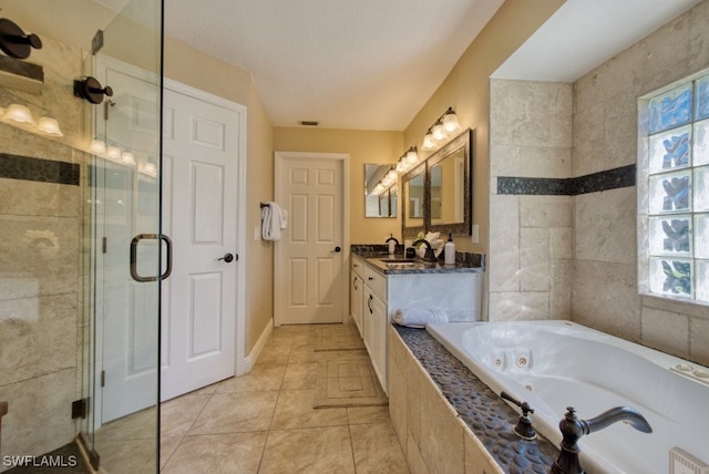 bathroom featuring plus walk in shower, vanity, and tile patterned floors