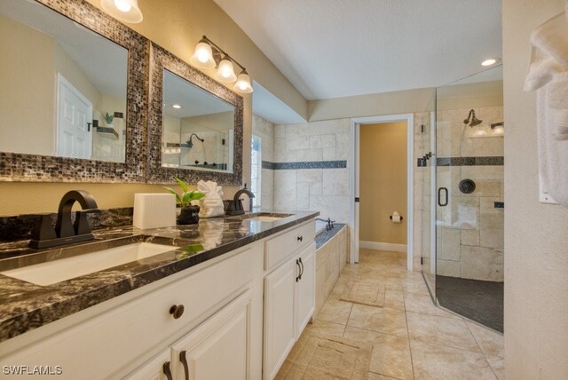 bathroom featuring vanity and plus walk in shower