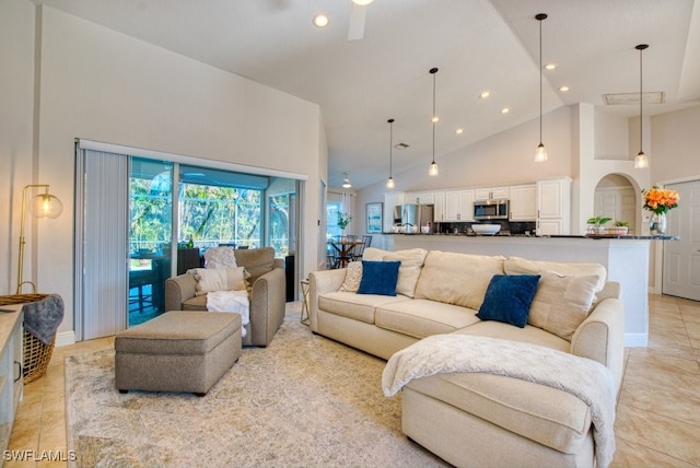 living room featuring high vaulted ceiling and light tile patterned floors