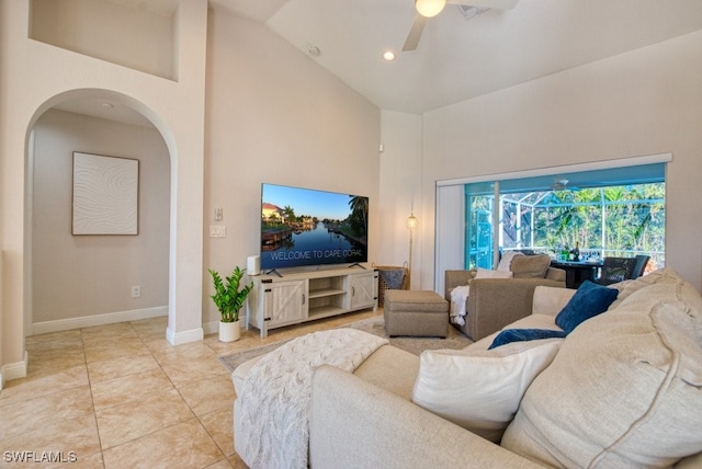 living room featuring ceiling fan, light tile patterned floors, and high vaulted ceiling