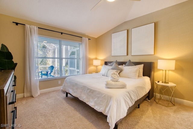 carpeted bedroom featuring ceiling fan and vaulted ceiling