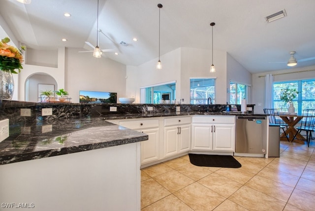 kitchen with dishwasher, high vaulted ceiling, ceiling fan, dark stone countertops, and white cabinetry