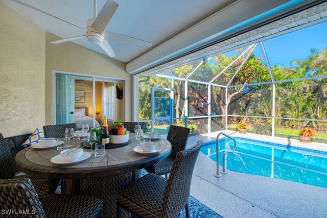 view of swimming pool featuring a patio, ceiling fan, and a lanai