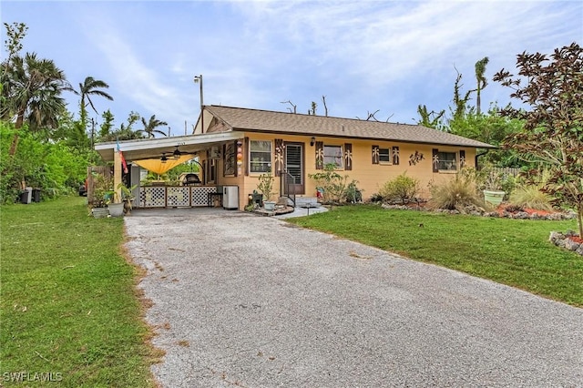 view of front of house with a front lawn and a carport