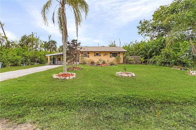 ranch-style home with a front yard and a carport