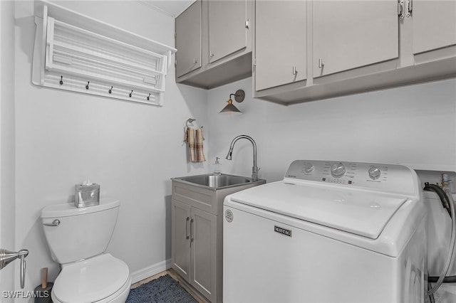 clothes washing area featuring sink and washer / dryer