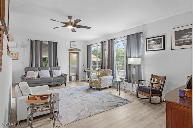 living room with light wood-type flooring and ceiling fan