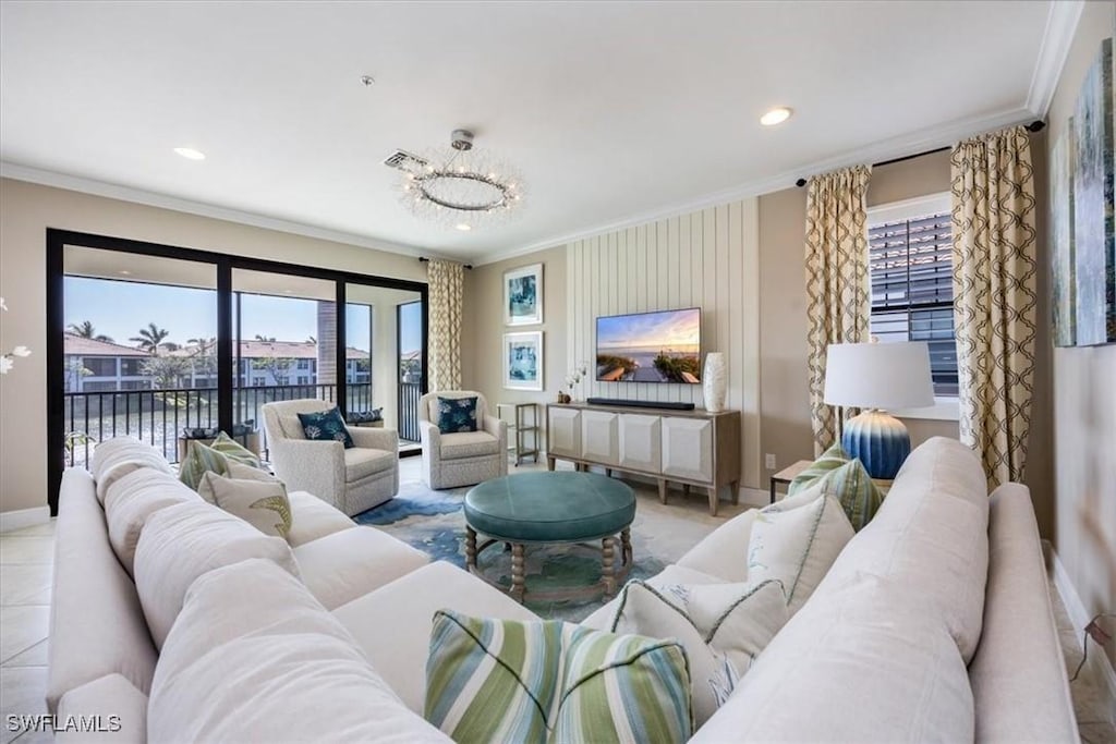 tiled living room with a chandelier, a water view, and ornamental molding