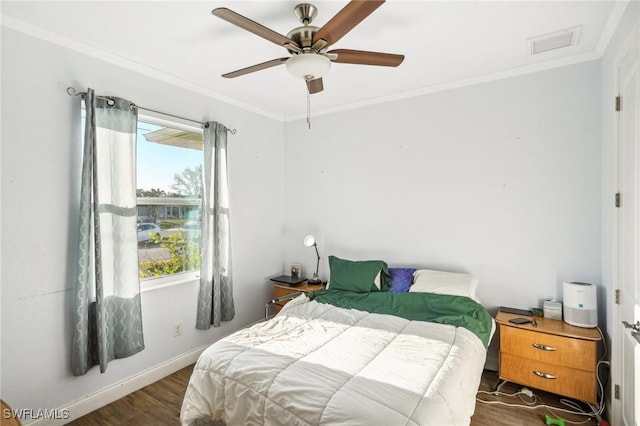 bedroom featuring dark hardwood / wood-style flooring, ceiling fan, and crown molding