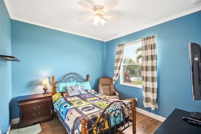 bedroom featuring ceiling fan, dark hardwood / wood-style flooring, and crown molding