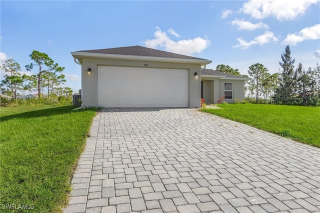 single story home featuring a garage, a front yard, and central AC unit