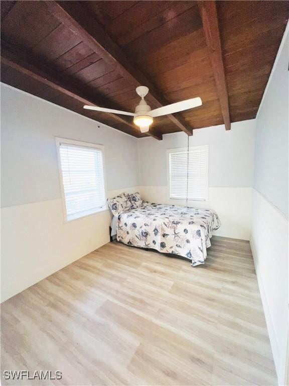 unfurnished bedroom with lofted ceiling with beams, light hardwood / wood-style flooring, ceiling fan, and wood ceiling