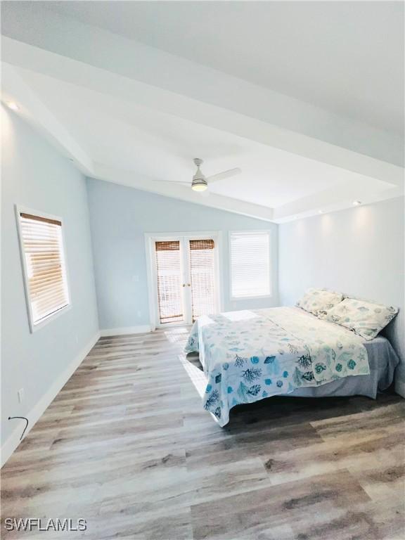 bedroom with access to outside, french doors, vaulted ceiling, ceiling fan, and light hardwood / wood-style floors